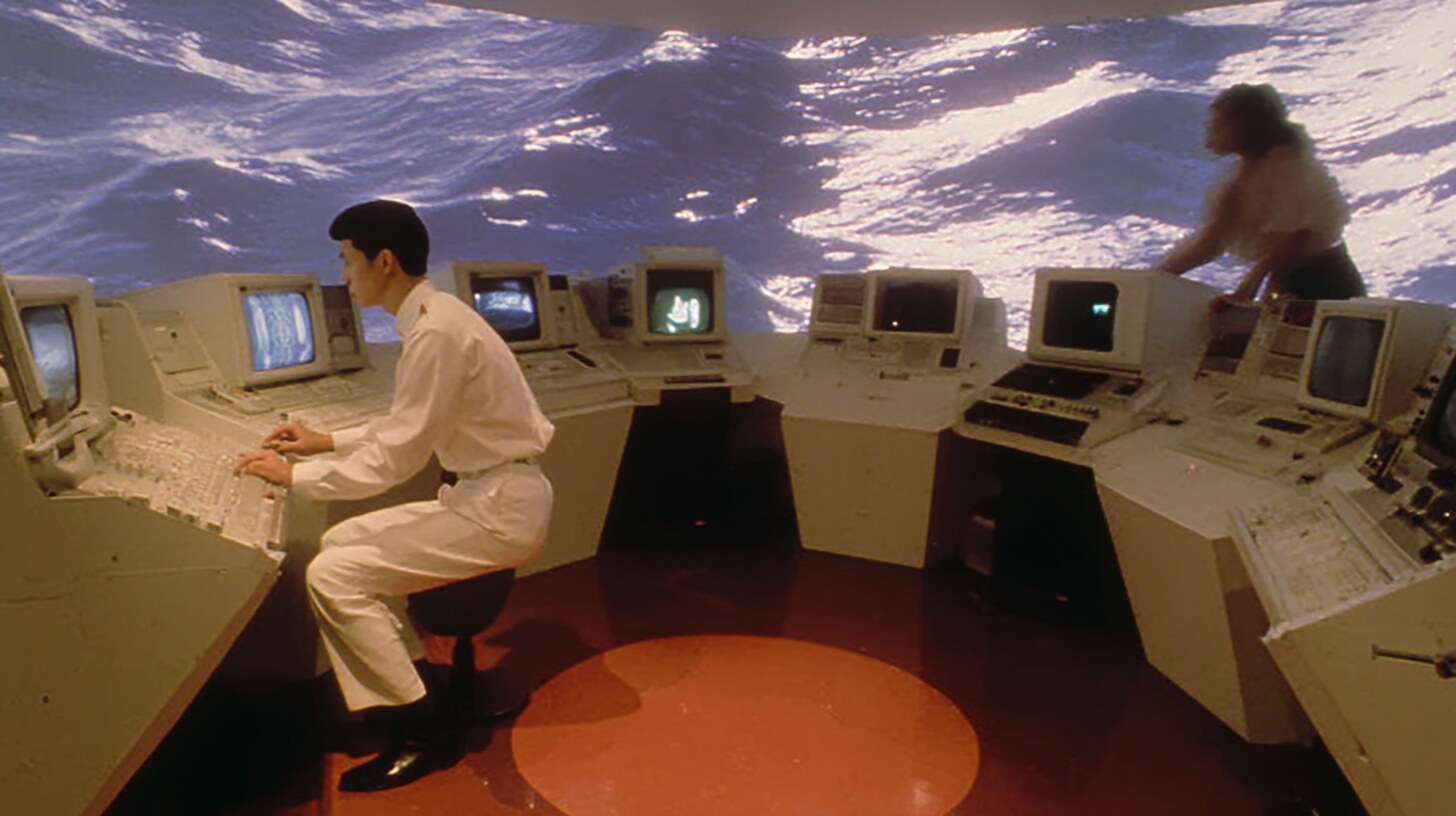 Doc Lâm's wave cave: a curved room, consoles, a wall of moving water.